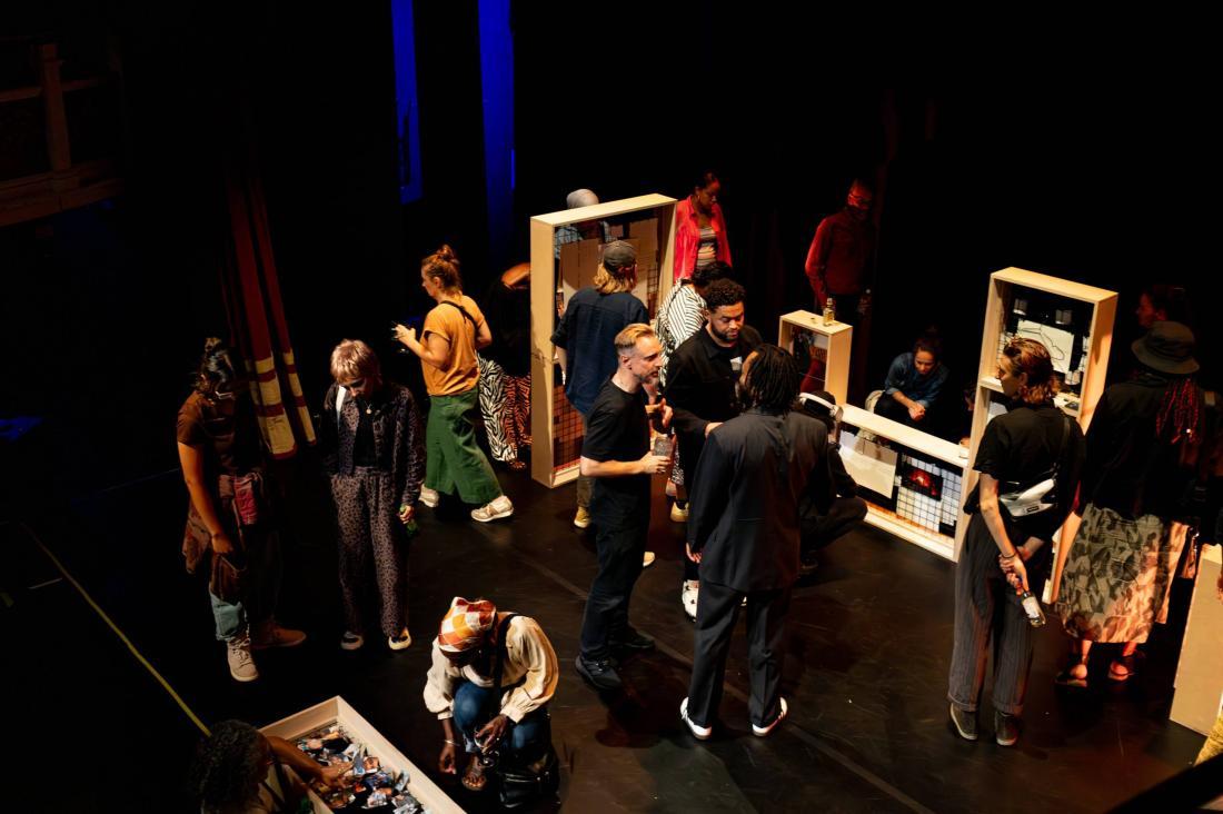 Audience members standing in theatre