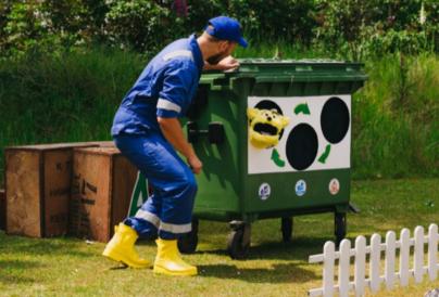 Aaron Spendelow as Riki Cycle with puppet in recycling bin