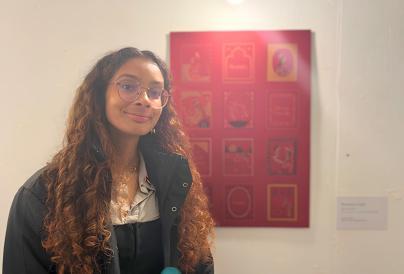 Ragavee - young woman, light brown hair woman standing in front of red portrait