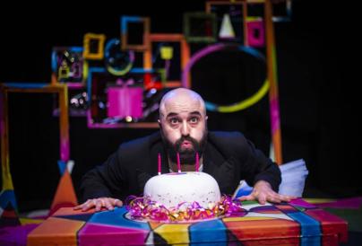 Children's theatre - man is blowing candles from a party cake
