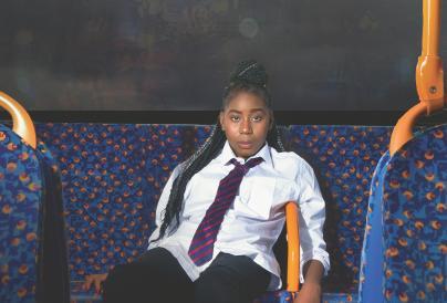 School girl sat at back of bus